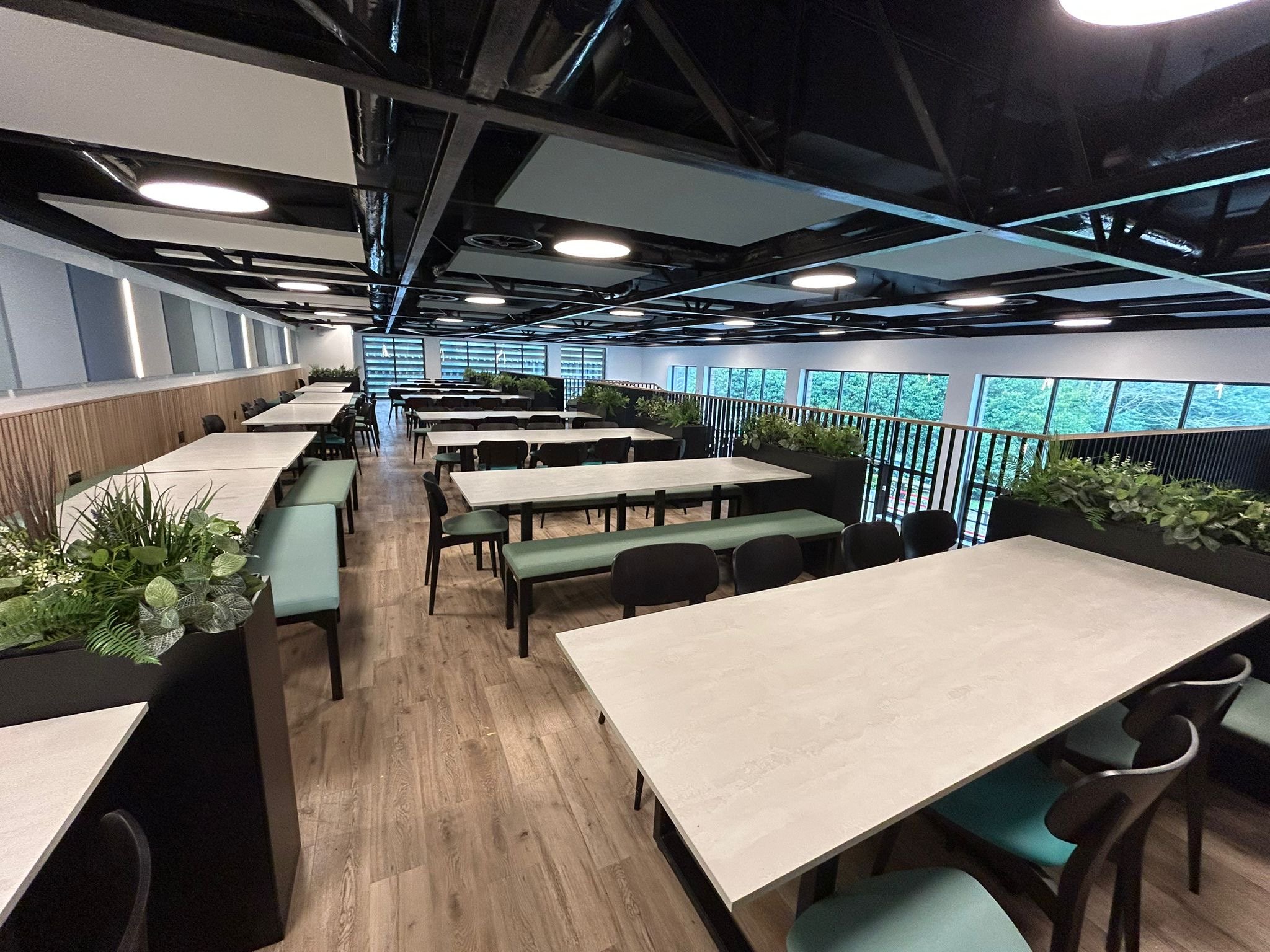 Lingfield College dining hall mezzanine lit by diVa PLUTO XL SUSPENDED pendants set among acoustic rafts